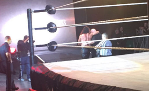 Rollins being helped to the back following the injury. Photo by @joantweetswwe on Twitter.