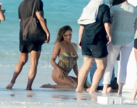 Ronda Rousey pictured on a sports Illustrated shoot with painted on swimsuit on a beach in the Bahamas