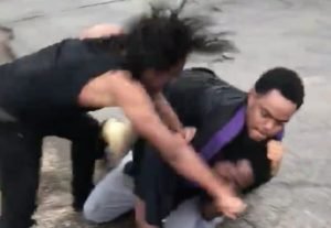 one man chokehold another man while his friend punch him in the face
