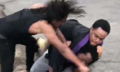 one man chokehold another man while his friend punch him in the face
