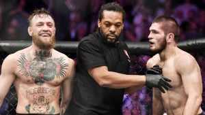 Conor McGregor laughs in Octagon with Khabib Nurmagomedov present