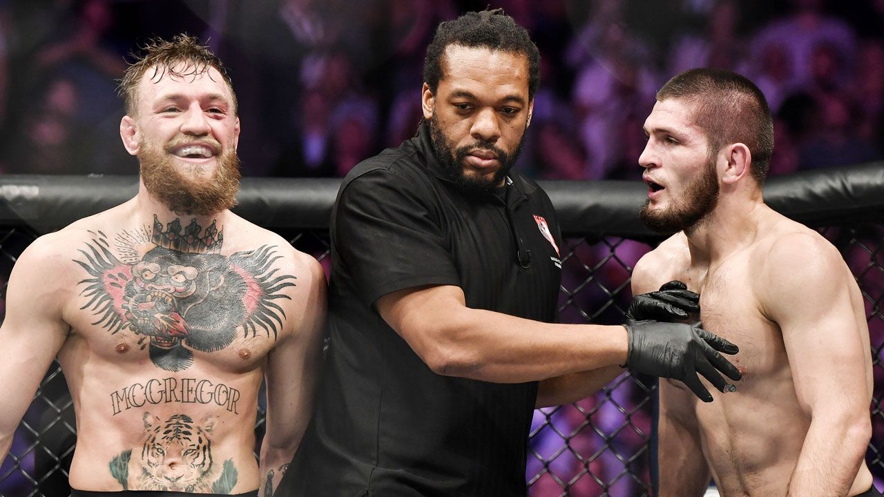Conor McGregor laughs in Octagon with Khabib Nurmagomedov present