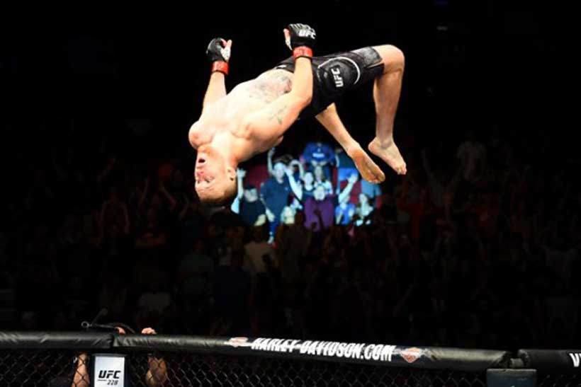 Justin Gaethje back flips in the octagon after winning a fight