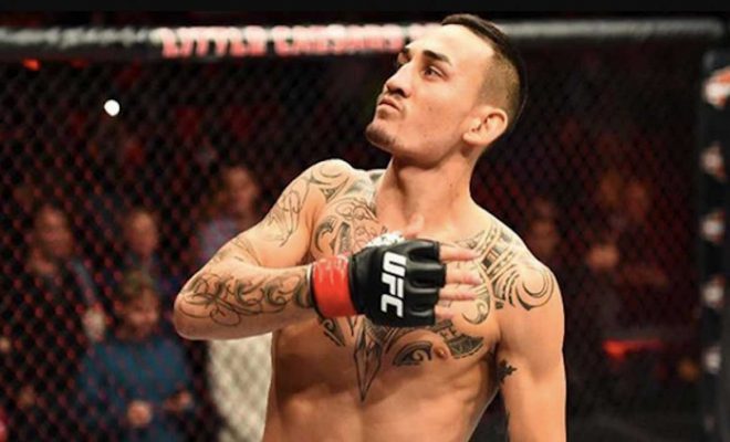 Max Holloway In UFC Octagon Looks Up to The Crowd